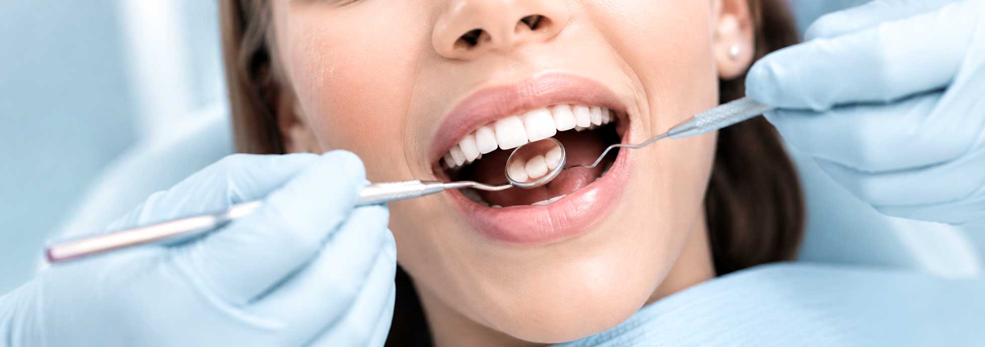 Paciente sonriendo mientras recibe un tratamiento dental profesional en una clínica dental.